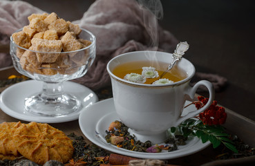 Tea hot drink on old background in composition on the table