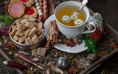 Tea hot drink on old background in composition on the table