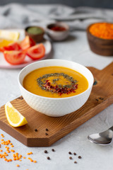 Thick red lentil soup served with lemon, dried mint and paprika. Turkish and Indian cuisine. Vertical orientation