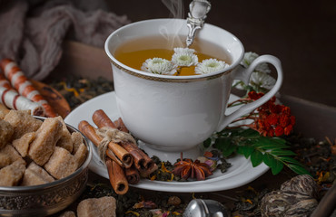 Tea hot drink on old background in composition on the table