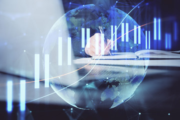 Double exposure of businessman with laptop and stock market forex chart.