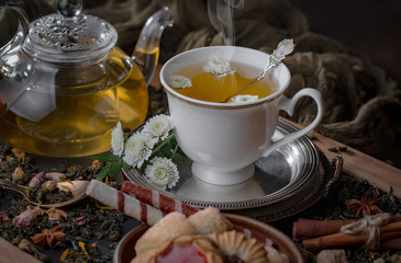 Tea hot drink on old background in composition on the table