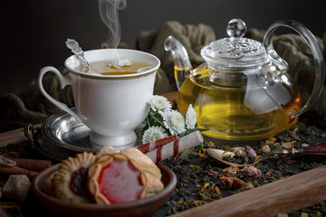 Tea hot drink on old background in composition on the table