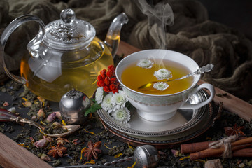 Tea hot drink on old background in composition on the table