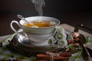 Tea hot drink on old background in composition on the table