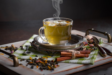 Tea hot drink on old background in composition on the table