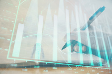 Forex graph on hand taking notes background. Concept of research. Multi exposure