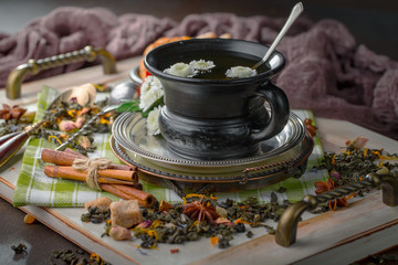 Tea hot drink on old background in composition on the table