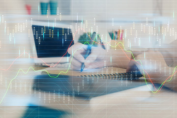 Financial graph displayed on woman's hand taking notes background. Concept of research. Double...