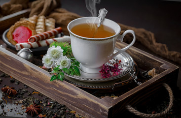 Tea hot drink on old background in composition on the table