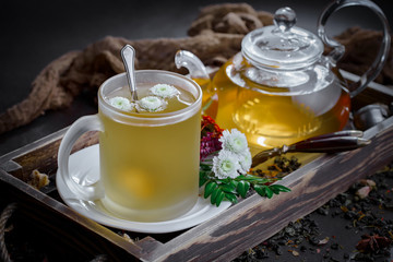 Tea hot drink on old background in composition on the table