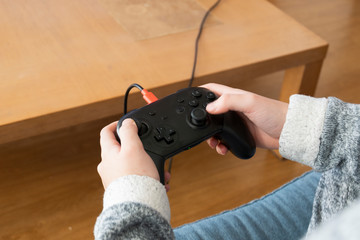 A young girl playing video games at home