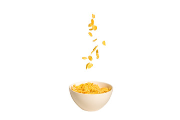 Corn flakes falling to the white bowl. Motion.
