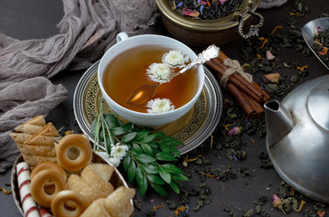 Tea hot drink on old background in composition on the table