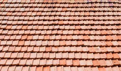 Texture of old red clay roof tiles on a building roof