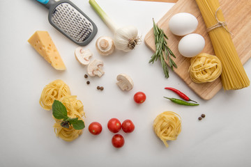 Fototapeta na wymiar Ingredients for pasta cooking on white background
