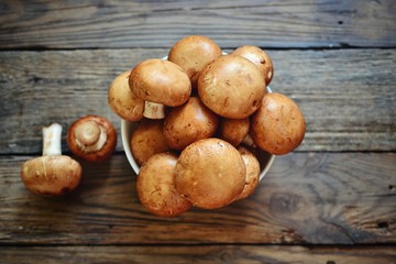Royal fresh mushrooms on a wooden background. Whole brown  mushrooms