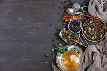 Dry tea leaves on a side background