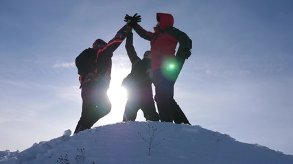 travelers met on top of success. Tourists come to top of snowy hill and rejoice at victory against...