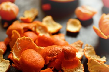 Mandarin peel on a dark background. Peel of an orange for a decor, tangerine and orange peel.