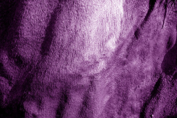 Grungy leather texture on sun in purple tone.