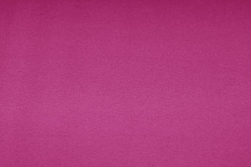 Plastic glittering texture with blur effect in pink tone.
