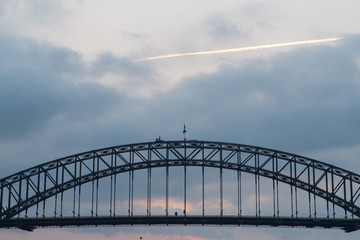 Cloudy sky above Sydney Harbour Bridge.