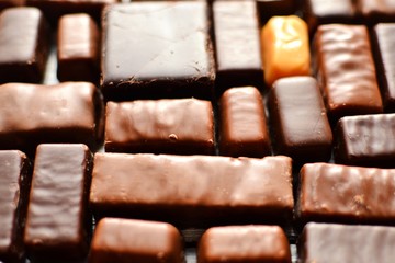 Assortment of chocolates. Candy background wallpaper. Top view place for text. Dark chocolate. Chocolate bars. White background 