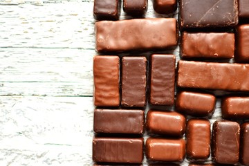 Assortment of chocolates. Candy background wallpaper. Top view place for text. Dark chocolate. Chocolate bars. White background 