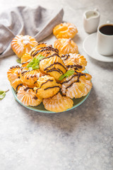 Profiteroles or gougeres (choux à la crème) - French choux pastry balls filled with custard or cottage cheese sprinkled with powdered sugar