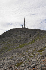 Fototapeta na wymiar View to the Gullsvagfjellet TV Tower in cloudy sky over a Gullsvågfjellet Mountain on Vega island, Norway in Vega archipelago mountains on summer day