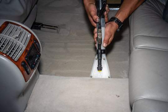 Cleaning of interior of the car with vacuum cleaner