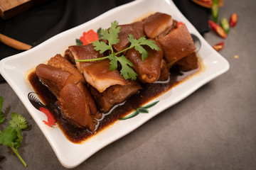 Delicious braised pig knuckles on the table at the Chinese restaurant.