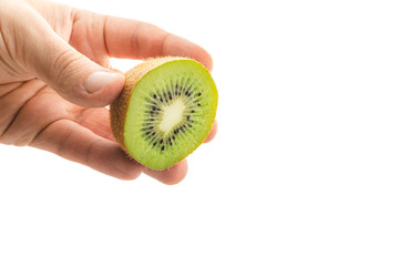 Hand holds sliced half of kiwi fruit isolated on white background