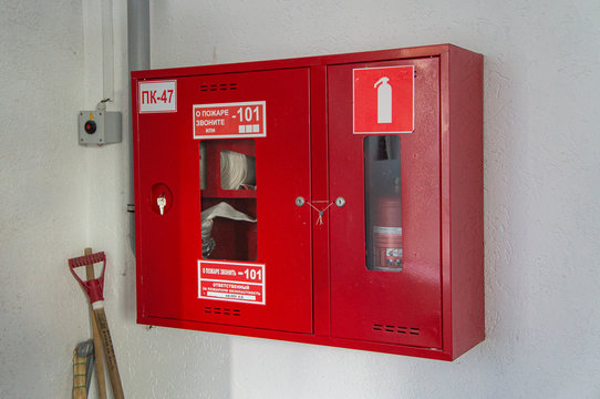 Red fire shield with fire extinguisher in a business center.