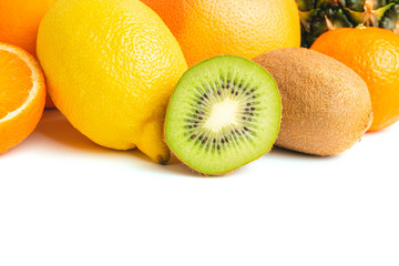 Assortment of tropical fruits, group of kiwi, orange, tangerine, lemon, pineapple, grapefruit isolated on white background