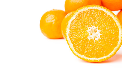 Sliced round halves of orange fruit and whole citrus isolated on white background