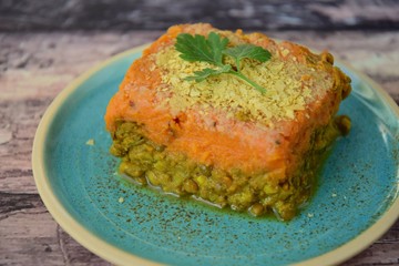 Vegan green lentil sweet potato Shepherd's pie garnish with nutritional yeast and parsley 