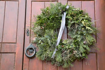 Green Christmas Wreath on Wooden Door
