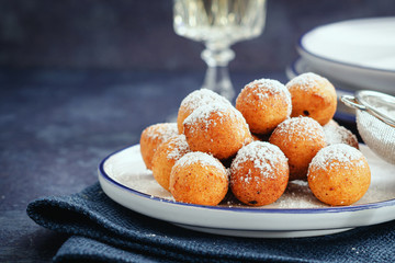 Castagnoli- italian fritters in carnival on white plate.