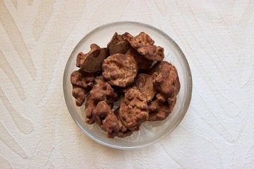 Homemade chocolate candies in a glass bowl. Top view, closeup