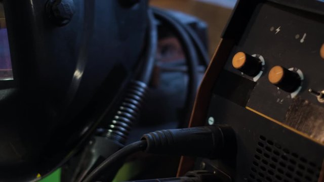 Close-up of welding equipment. Protective mask and gas cylinders in workshop