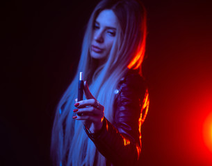 Girl smoking e-cigarette close up. New device for vaping and smoking