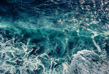 Aerial view to waves in ocean Splashing Waves. Blue clean wavy sea water. Seething waves with foam.