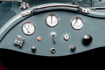 Fragment of interior retro car with speedometer, toggle switches. vintage style