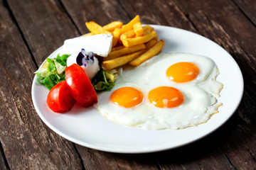 Delicious fried eggs with side dish
