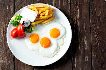 Delicious fried eggs with side dish