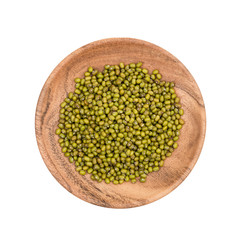 Wooden plate with green mung beans seen directly from above and isolated on white background