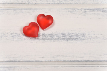 Two red hearts on white wooden background, love concept for Valentines Day