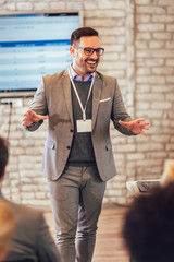 Speaker giving a talk in conference hall at business event.